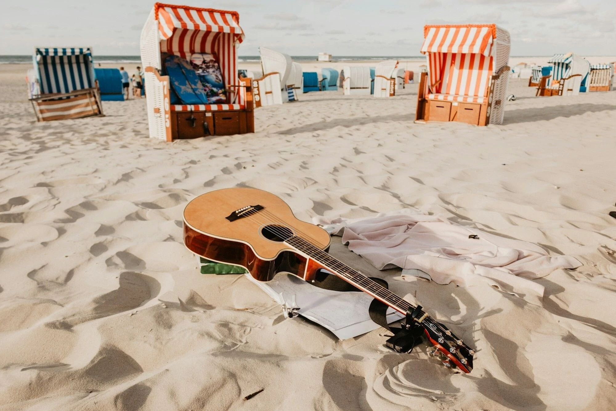 Beach with a Guitar laying on the sand with an overlaying countdown to Summer recital on June 21st at 3 pm and 5pm.